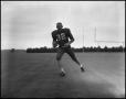 Photograph: [Football Player No. 32 Running with the Ball, September 1962]