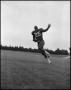 Photograph: [Football Player No. 25 Running with a Football, September 1962]