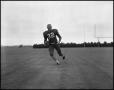 Photograph: [Football Player No. 32 Running with a Football, September 1962]