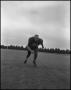 Photograph: [Football Player No. 61 Running Low on the Field, September 1962]