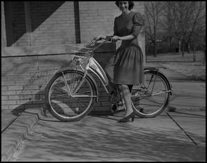 Primary view of object titled '[Marie Rather with a bicycle]'.