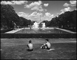 Primary view of object titled '[Two Men Sunbathing on Lawn near the pool]'.