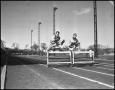 Photograph: [Two Athletes Jumping over Hurdles]