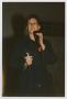 Photograph: [Louise Young giving a speech while holding a vigil candle]