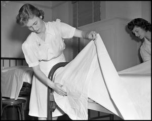 Primary view of object titled '[Women making beds]'.