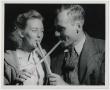 Photograph: [Couple Sampling Molasses with Sop Stick]