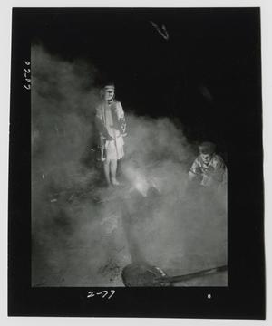 Primary view of object titled '[Young Boy and Girl Warming their Hands and Watching the Molasses Boil Down]'.