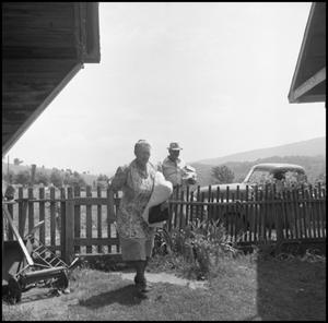 Primary view of object titled '[Woman and man at an outdoor quilting bee]'.