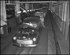 Primary view of object titled '[Automobiles on an assembly line]'.