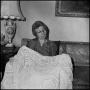 Photograph: [Unidentified alumna showing off a blanket, 3]