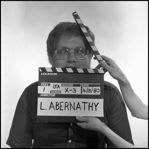 Primary view of object titled '[Portrait of Lewis Abernathy behind a clapperboard, 5]'.