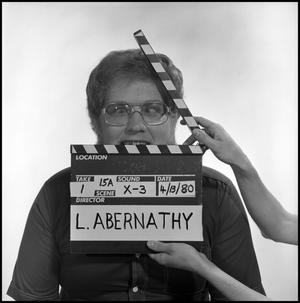 Primary view of object titled '[Portrait of Lewis Abernathy behind a clapperboard, 2]'.