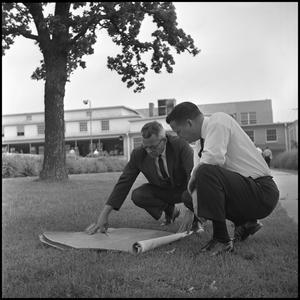 Primary view of object titled '[Dr. Farmer and Dr. Spurlock Reviewing Building Plans for the New Student Union]'.