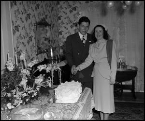 Primary view of object titled '[Bride and Groom with Wedding Cake]'.