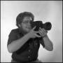 Primary view of [Lewis Abernathy posing with film camera, 2]