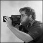 Primary view of [Filmmaker Lewis Abernathy looking through camera, 3]
