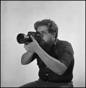Primary view of object titled '[Filmmaker Lewis Abernathy with camera]'.