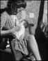 Thumbnail image of item number 1 in: '[Mother Nursing Baby in Bedroom]'.