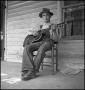 Photograph: [Young Man on Porch Playing Guitar]