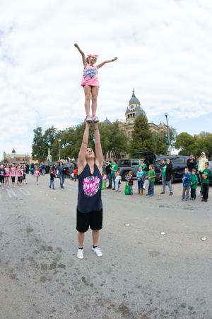 Primary view of object titled '[Cheerleading group at UNT Homecoming Parade]'.