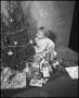 Photograph: [Douglas Clark with a Christmas tree]
