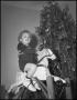 Photograph: [Young child riding on their new toy horse]