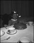 Photograph: [Little girl frowning at a cake]