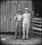 Photograph: [Raymond and Pappy Clark in front of a barn]