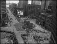 Thumbnail image of item number 1 in: '[Aerial photograph of a parade marching downtown, 1]'.