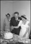 Photograph: [Joe and Bernice Clark cutting their wedding cake]