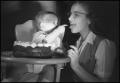 Photograph: [Baby feeding frosting to a woman]