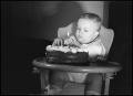 Photograph: [Baby poking a cake]
