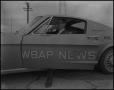 Photograph: [Bruce Neal in the WBAP News Car]