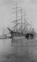 Primary view of [Two ships docked by the pier]