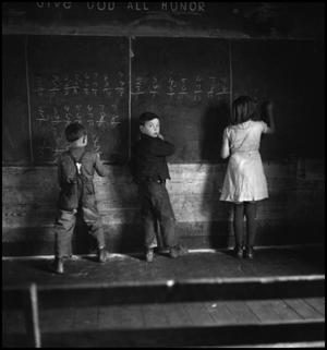 Primary view of object titled '[Children working at blackboard]'.
