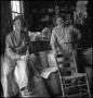 Photograph: [Two men in a feed store, 2]