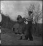 Photograph: [Student and teacher playing horseshoes]