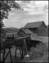 Photograph: [Man admiring a watermill]