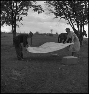 Primary view of object titled '[Putting down a picnic blanket]'.