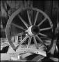 Photograph: [Wheel leaning against a wall]