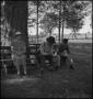 Photograph: [People sitting on a bench]