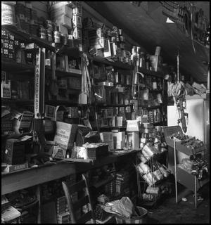 Primary view of object titled '[Shelves of a general store]'.