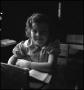Photograph: [Smiling student at her desk]