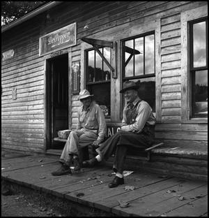 Primary view of object titled '[Two men chatting on a porch]'.