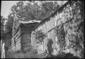 Photograph: [Standing by a house]