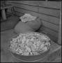 Thumbnail image of item number 1 in: '[Photo of a pot of potatoes next to a sack]'.