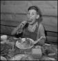 Photograph: [A boy eating at a table, 2]
