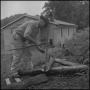 Photograph: [A man splitting wood, 4]