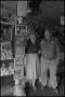 Photograph: [A couple in a general store, 3]