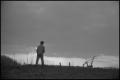 Photograph: [A boy standing on a hill]
